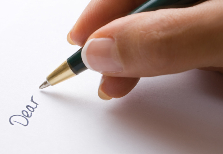 Photo of someone writing a letter